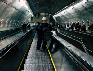 person riding on escalator photo thumbnail