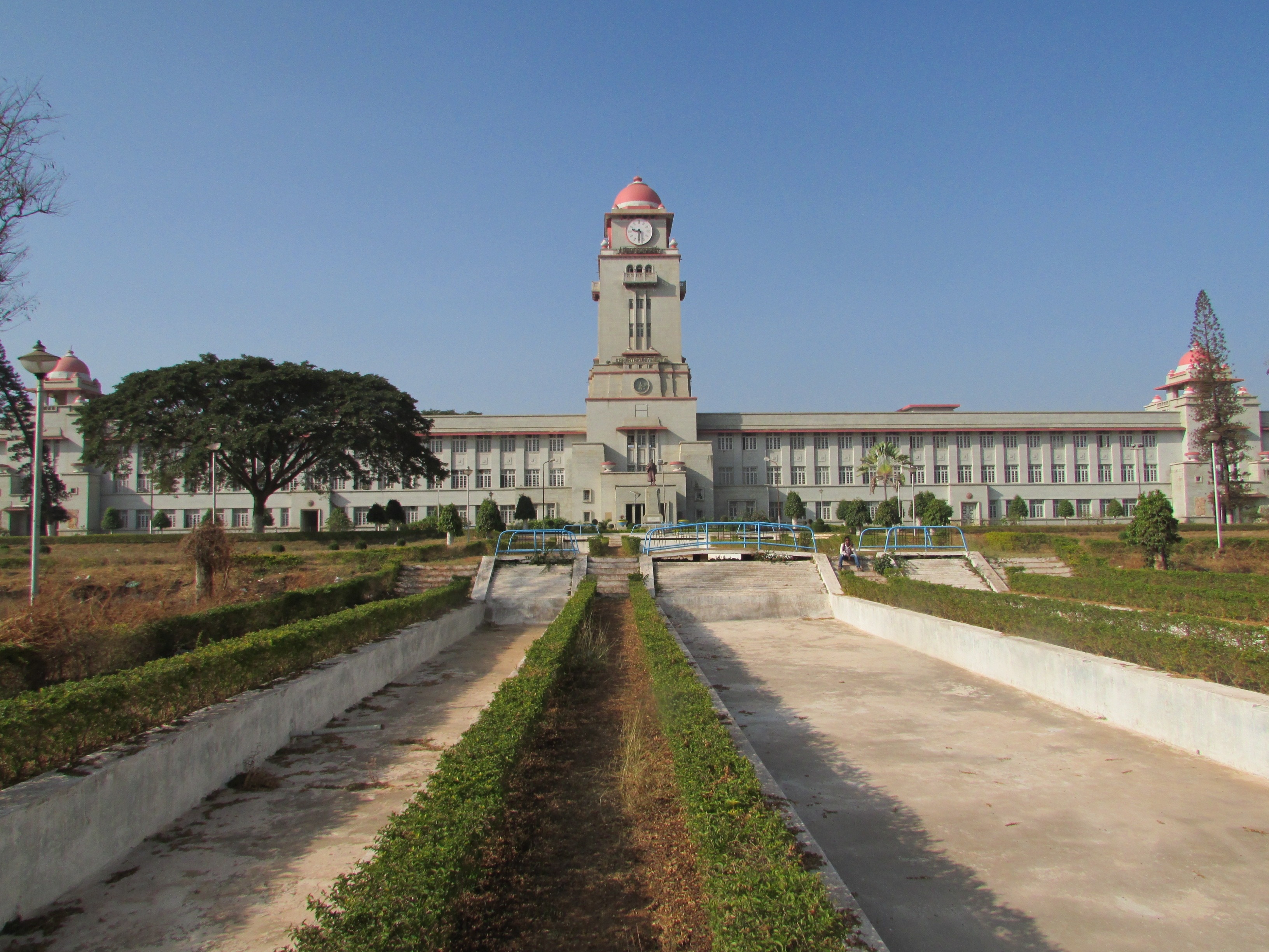 gray and red concrete building with tower clock