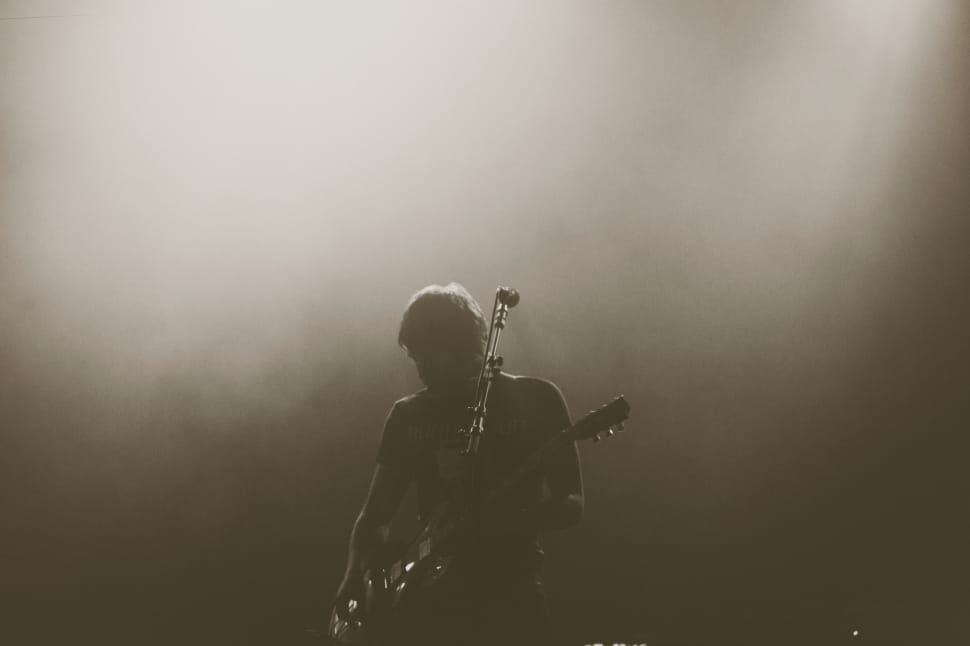grayscale photo of man playing guitar preview