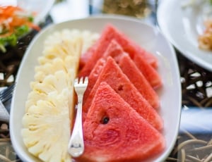 slices of watermelon and pineapple served on white rectangular plate thumbnail