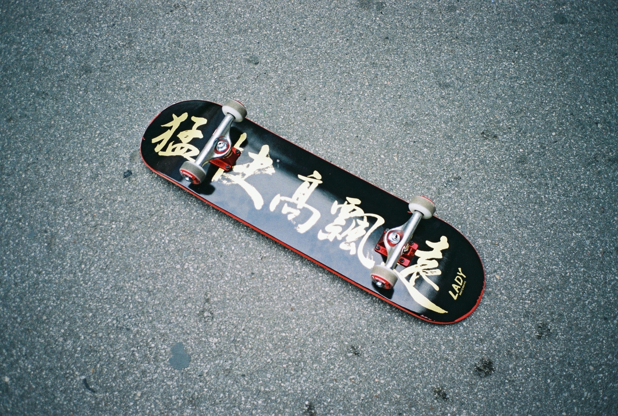 black and red kanji text lady skateboard
