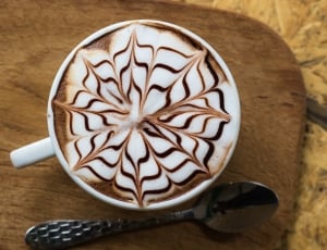floral latte art coffee filled white ceramic mug thumbnail