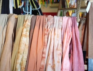 assorted textile on brown wooden rack thumbnail