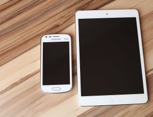 white samsung duos android smartphone and white ipad thumbnail
