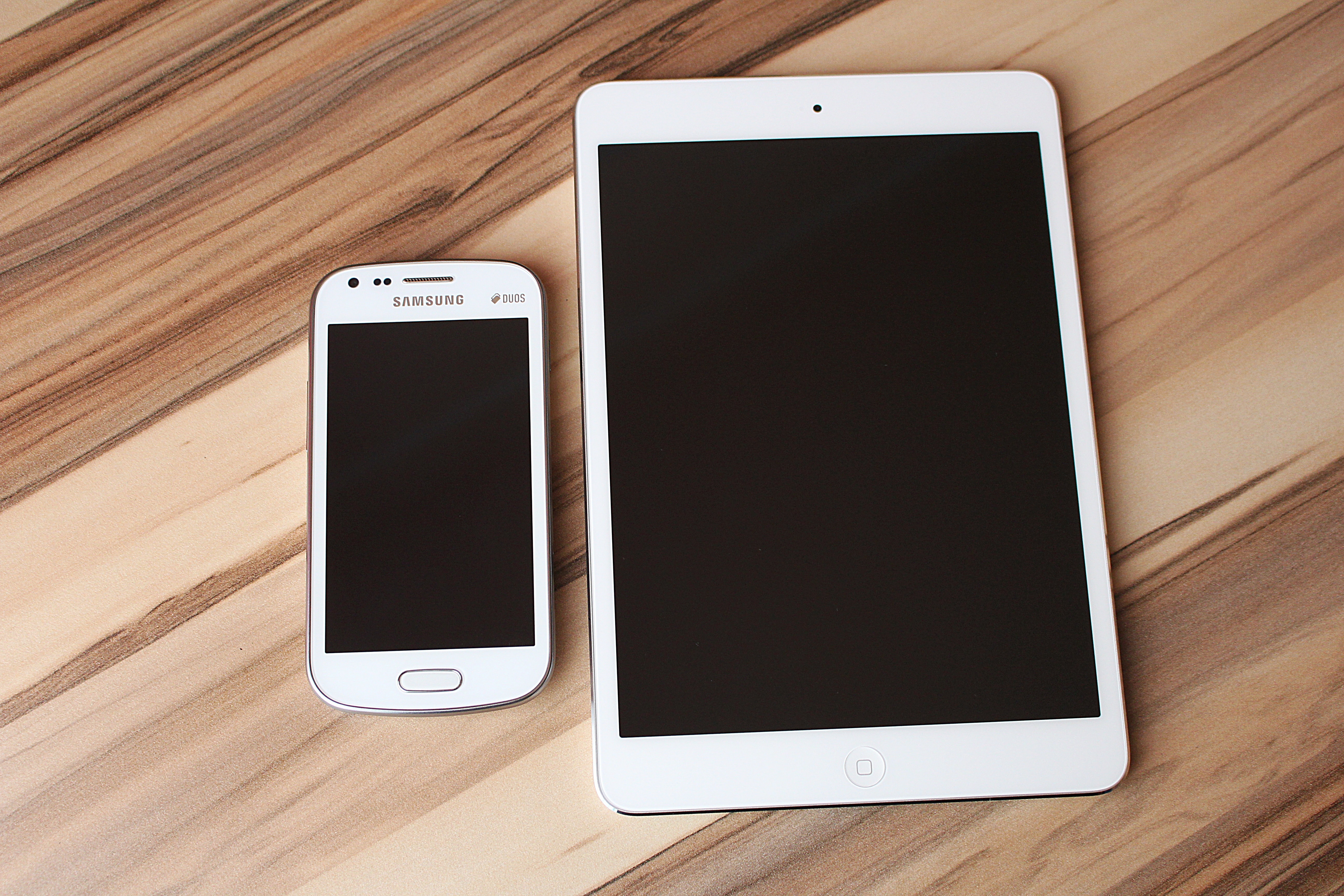 white samsung duos android smartphone and white ipad