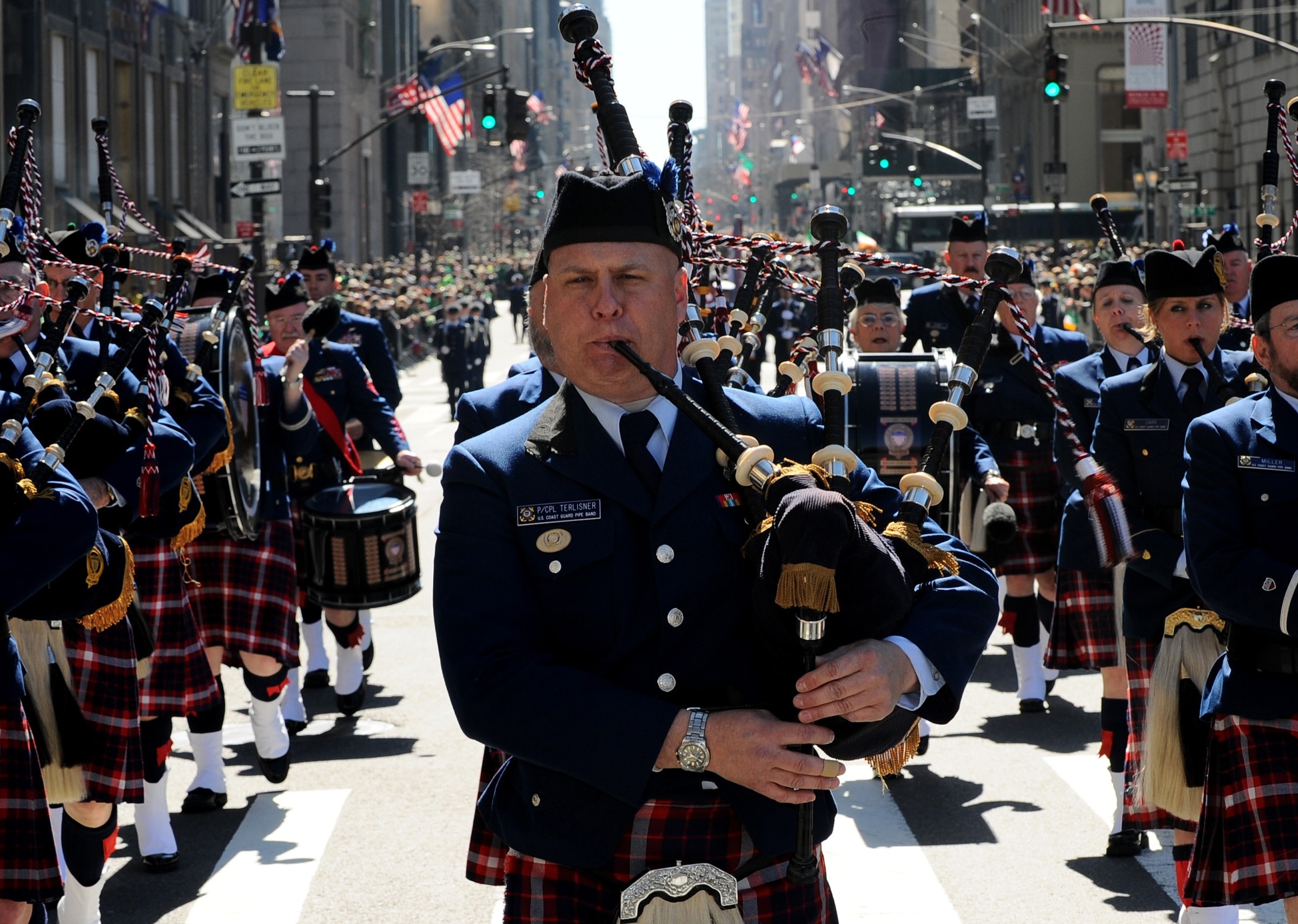 man in black and gray on parade playing bag pipes