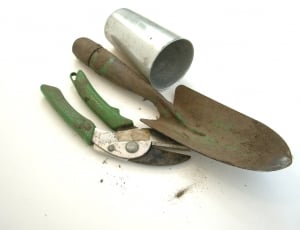 hand trowel; stainless steel cup; and green handled scissors thumbnail