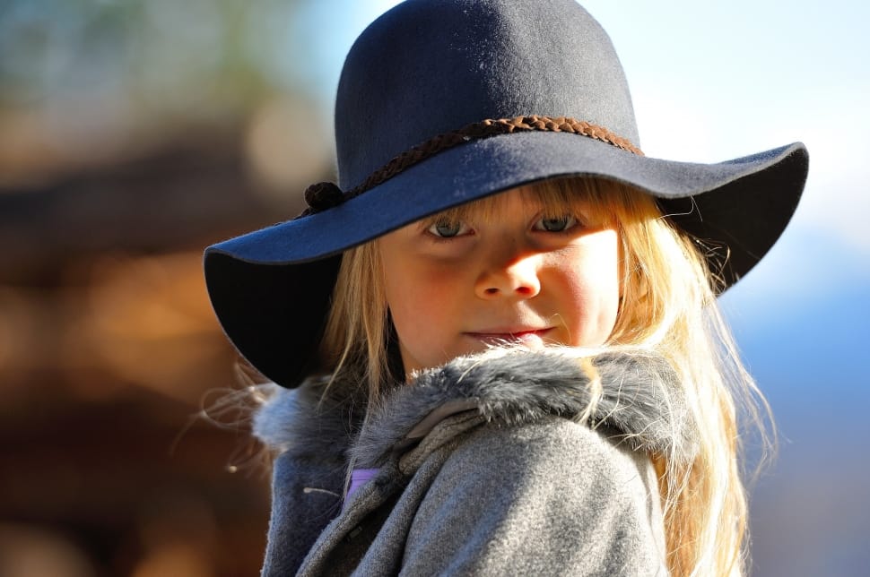 girl's black sunhat and gray winter coat preview
