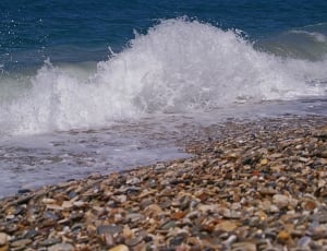 seashore surrounded by stones thumbnail
