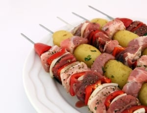 five pork and vegetable barbecues on white plate thumbnail