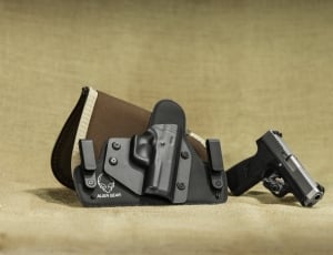 black and gray semi automatic pistol set on white textile thumbnail