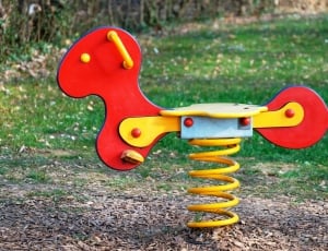 red and yellow spring rocking horse thumbnail
