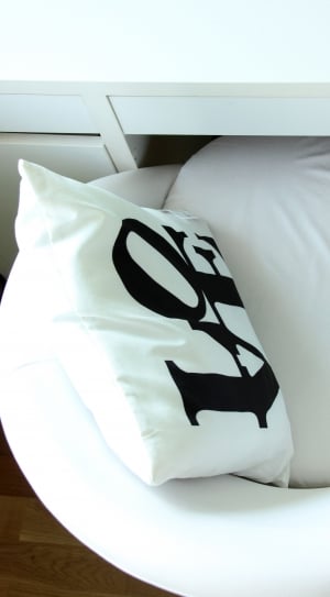 white and black LOVE Print throw pillow on sofa chair thumbnail