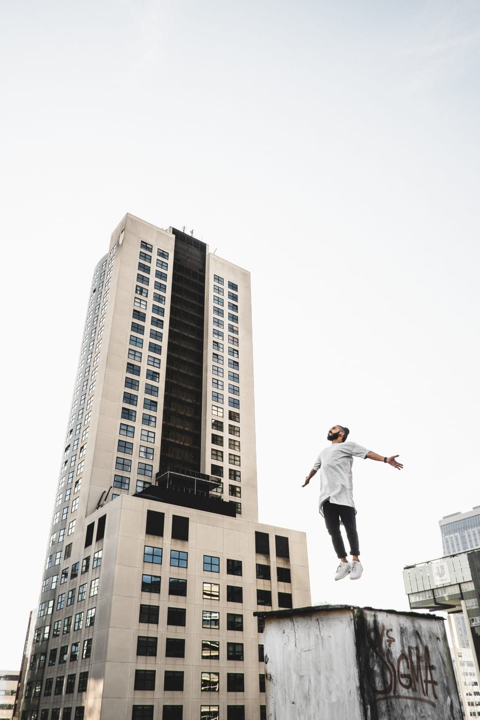 man in white shirt and black pants jumping preview