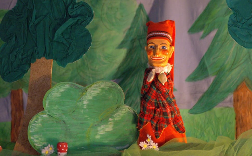 woman in red and green plaid puppet preview