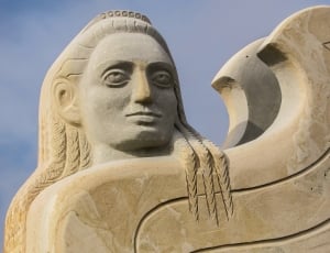 long haired man concrete statue thumbnail