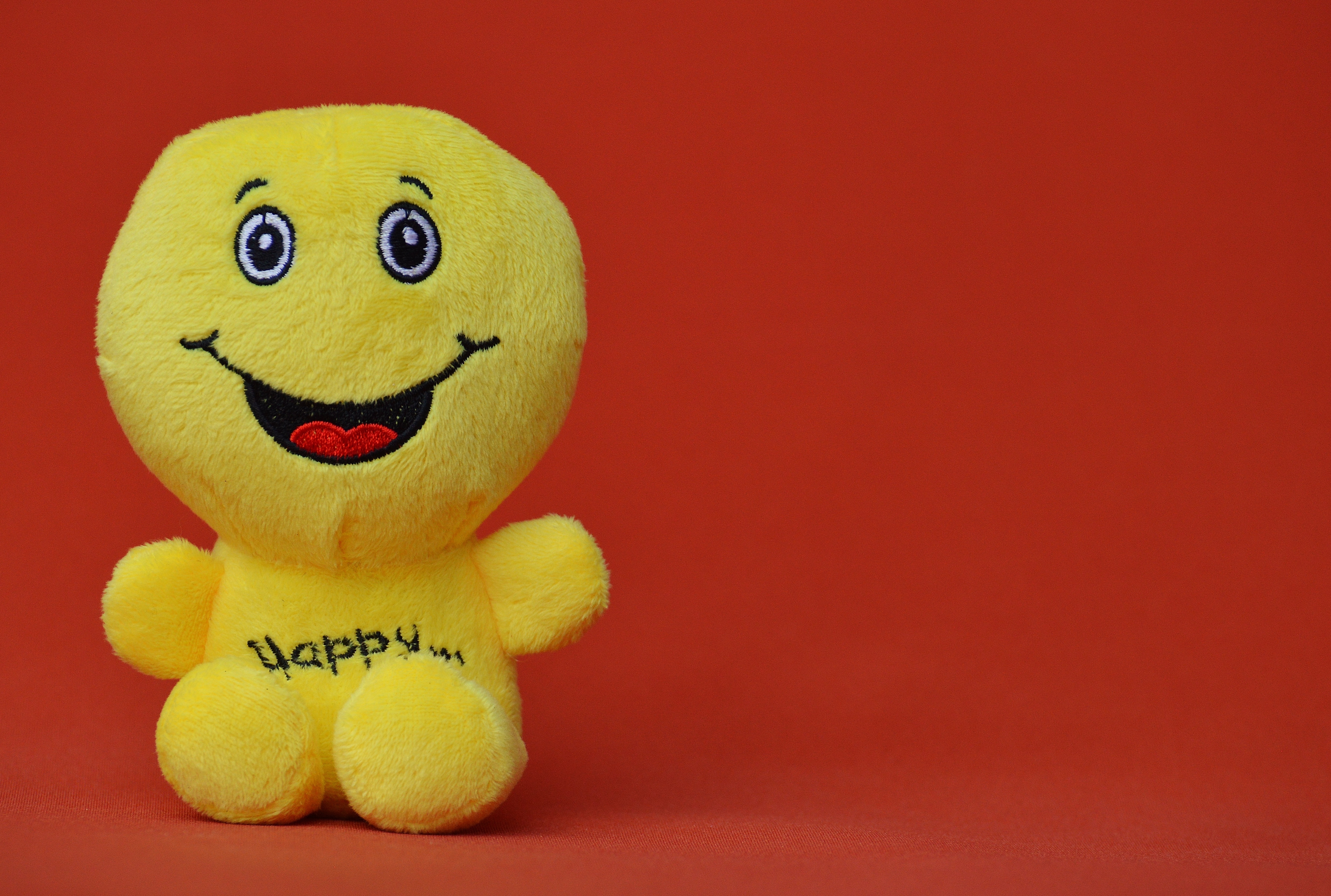 yellow happy plush toy