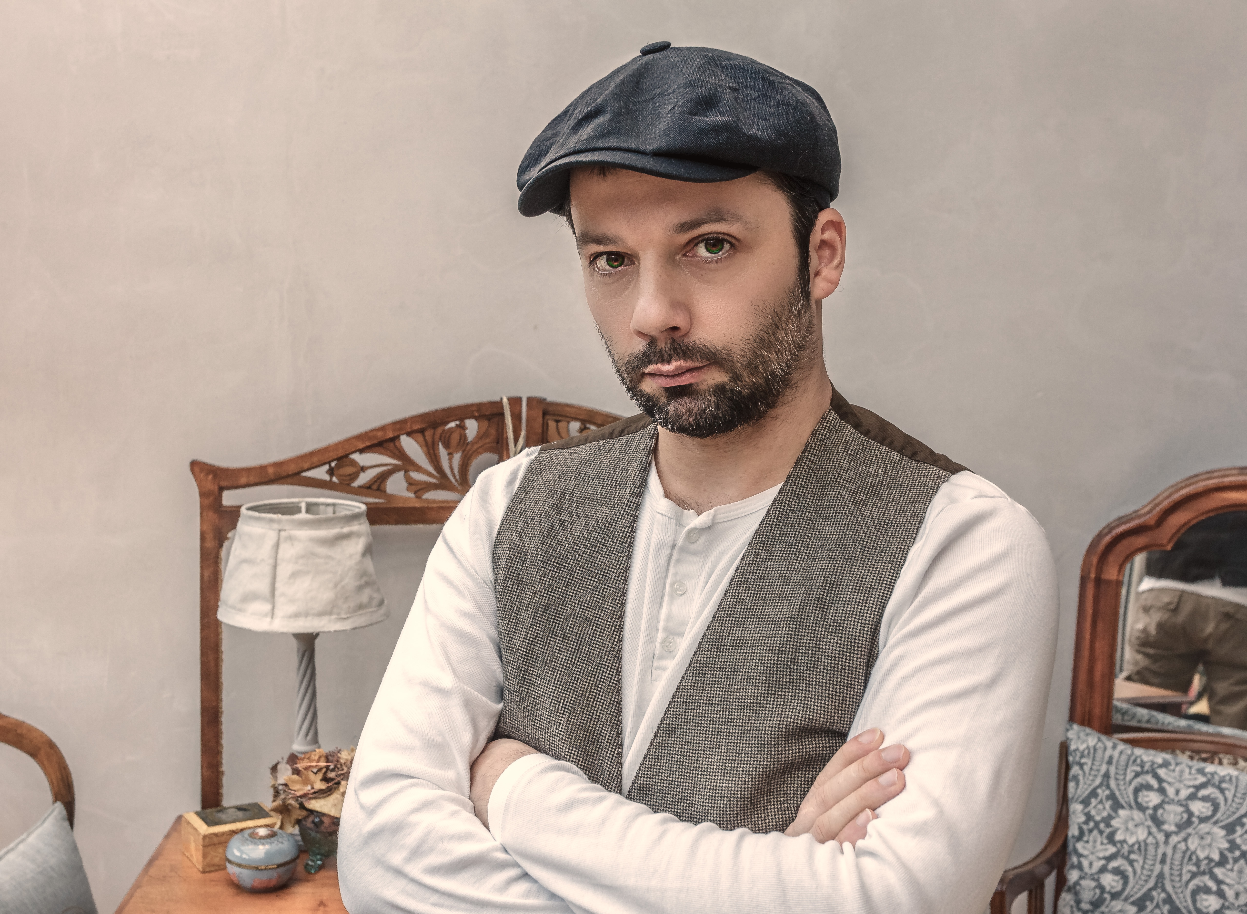 man in black newsboy hat
