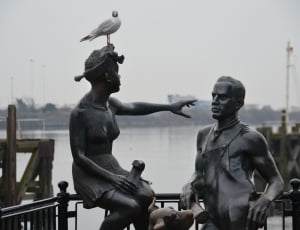 man and woman brass statue thumbnail