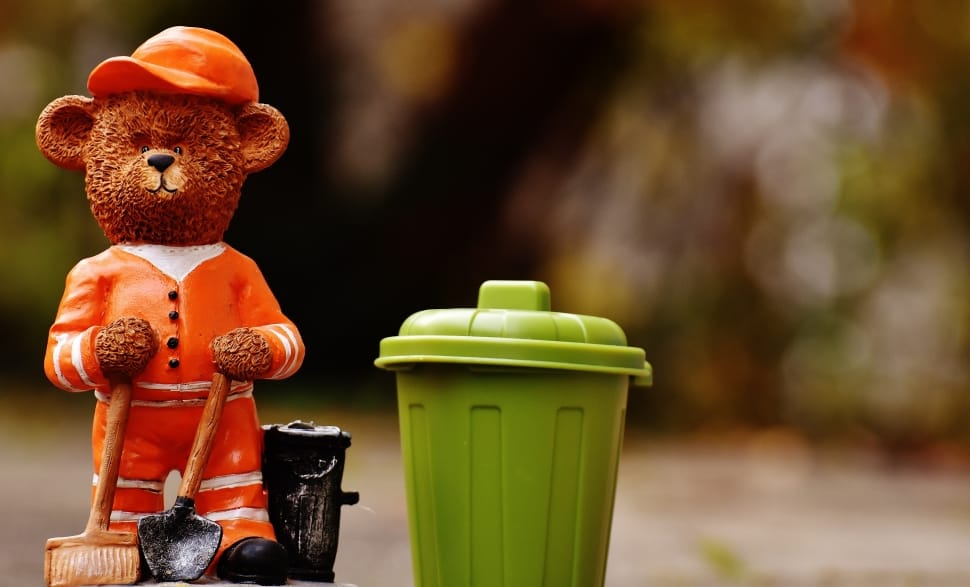 brown teddy bear and green trash bin figurine preview