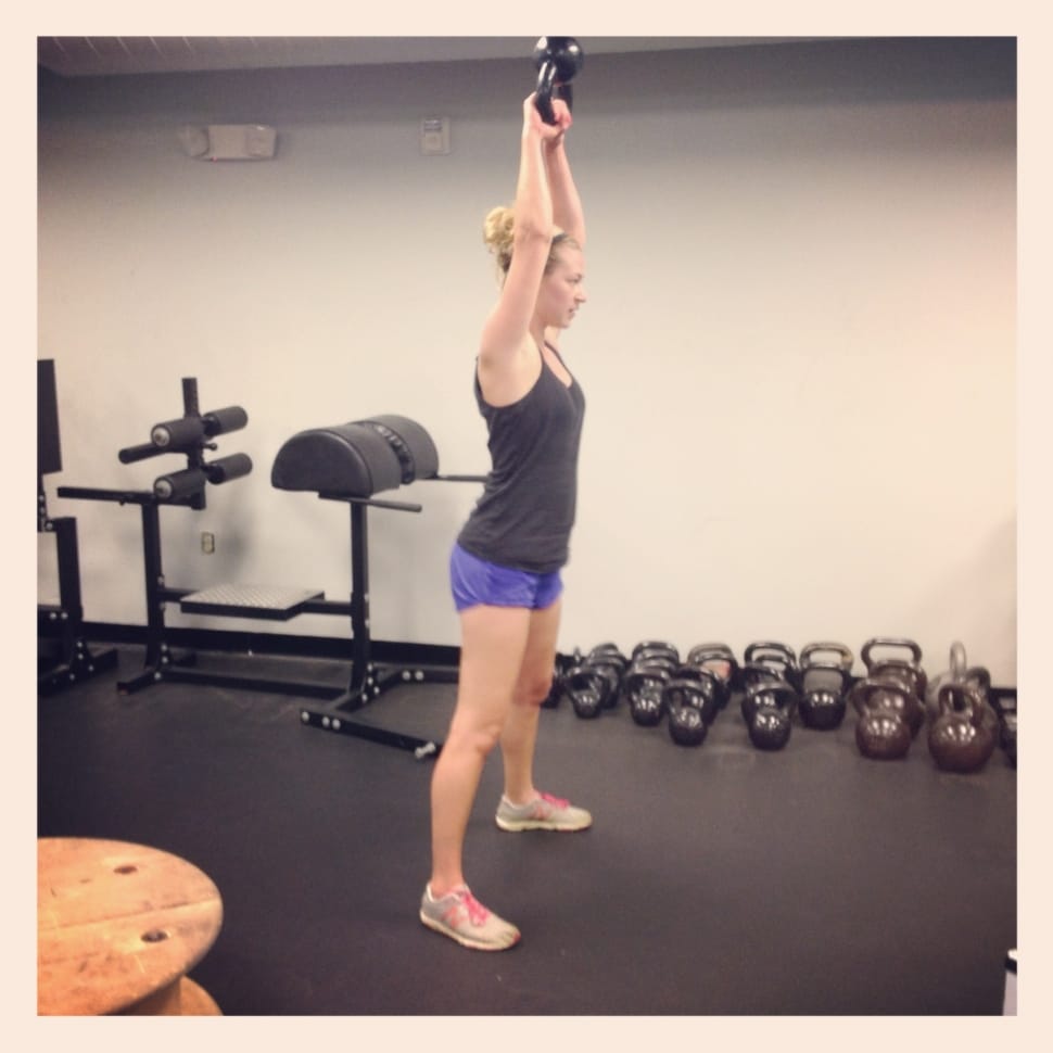 female inside the gym holding kettle bell preview