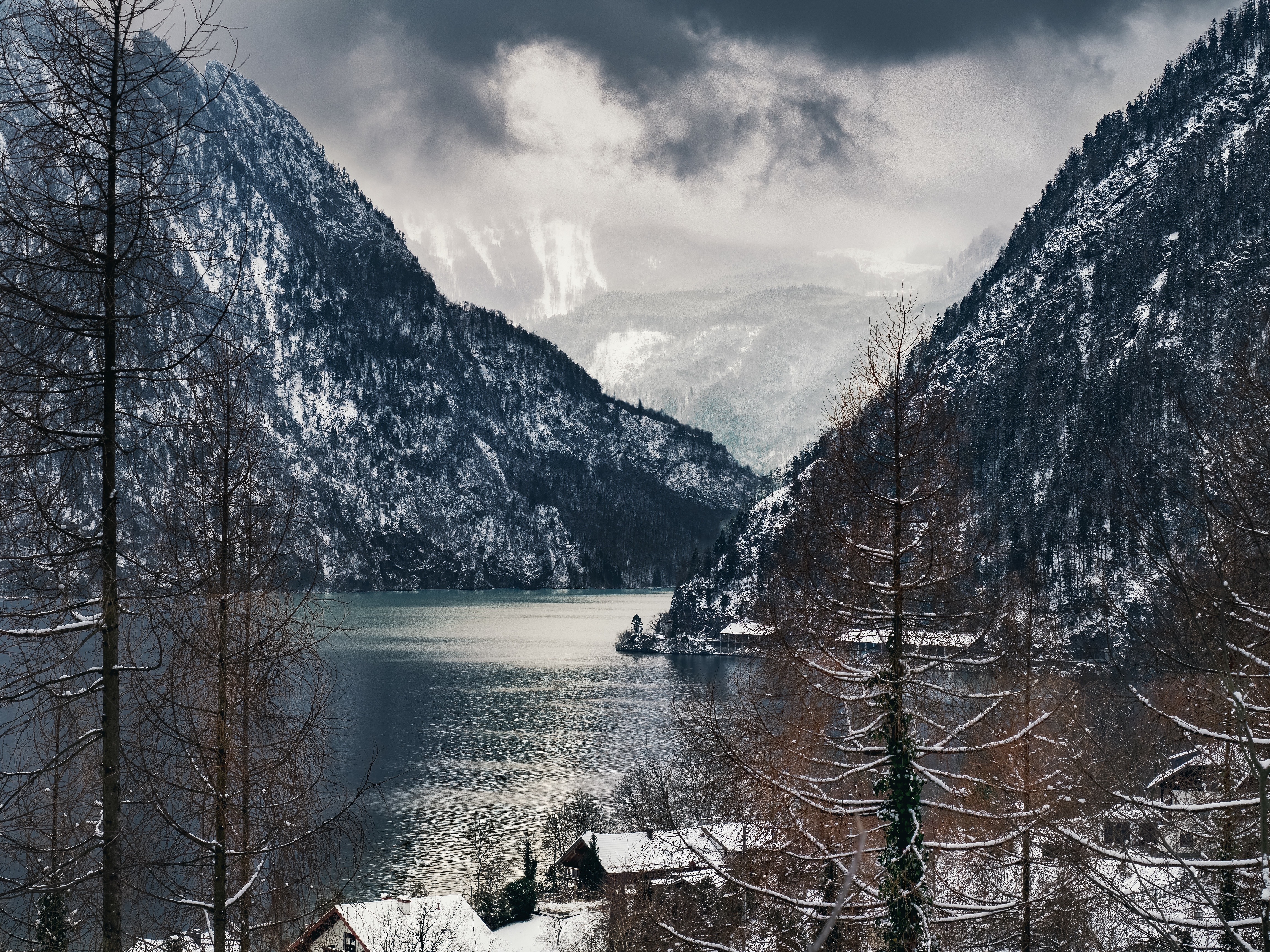 open body of water between snowed mountain view photo