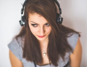 selective focus photo of woman wearing headphones thumbnail