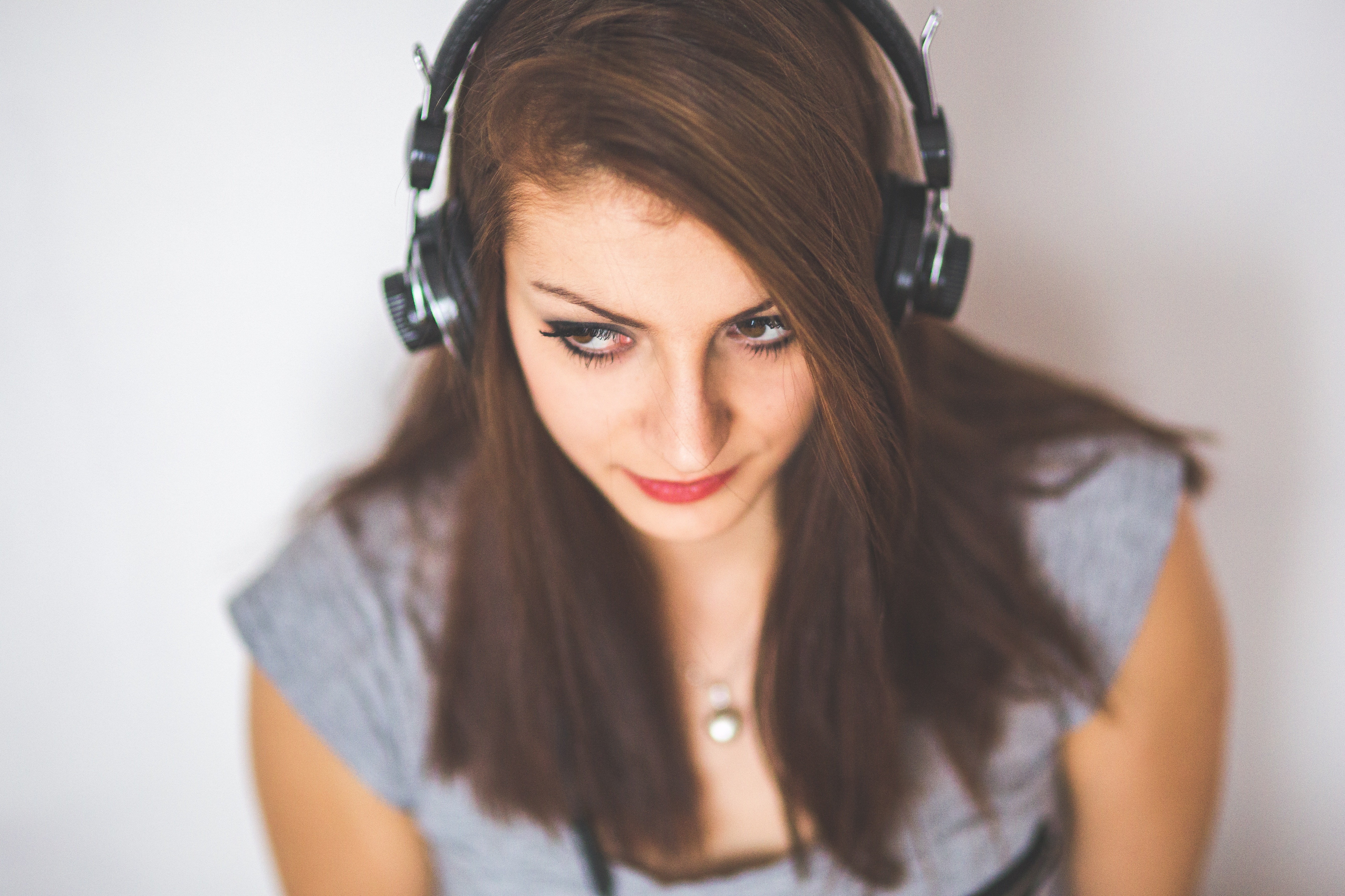 selective focus photo of woman wearing headphones