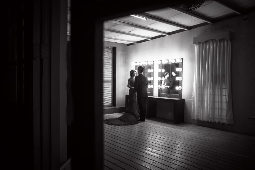 greyscale photo of couple near mirror preview