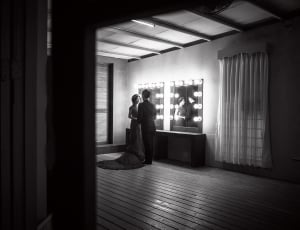 greyscale photo of couple near mirror thumbnail