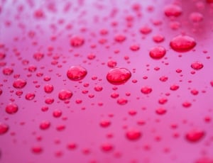 drops of water on red surface thumbnail
