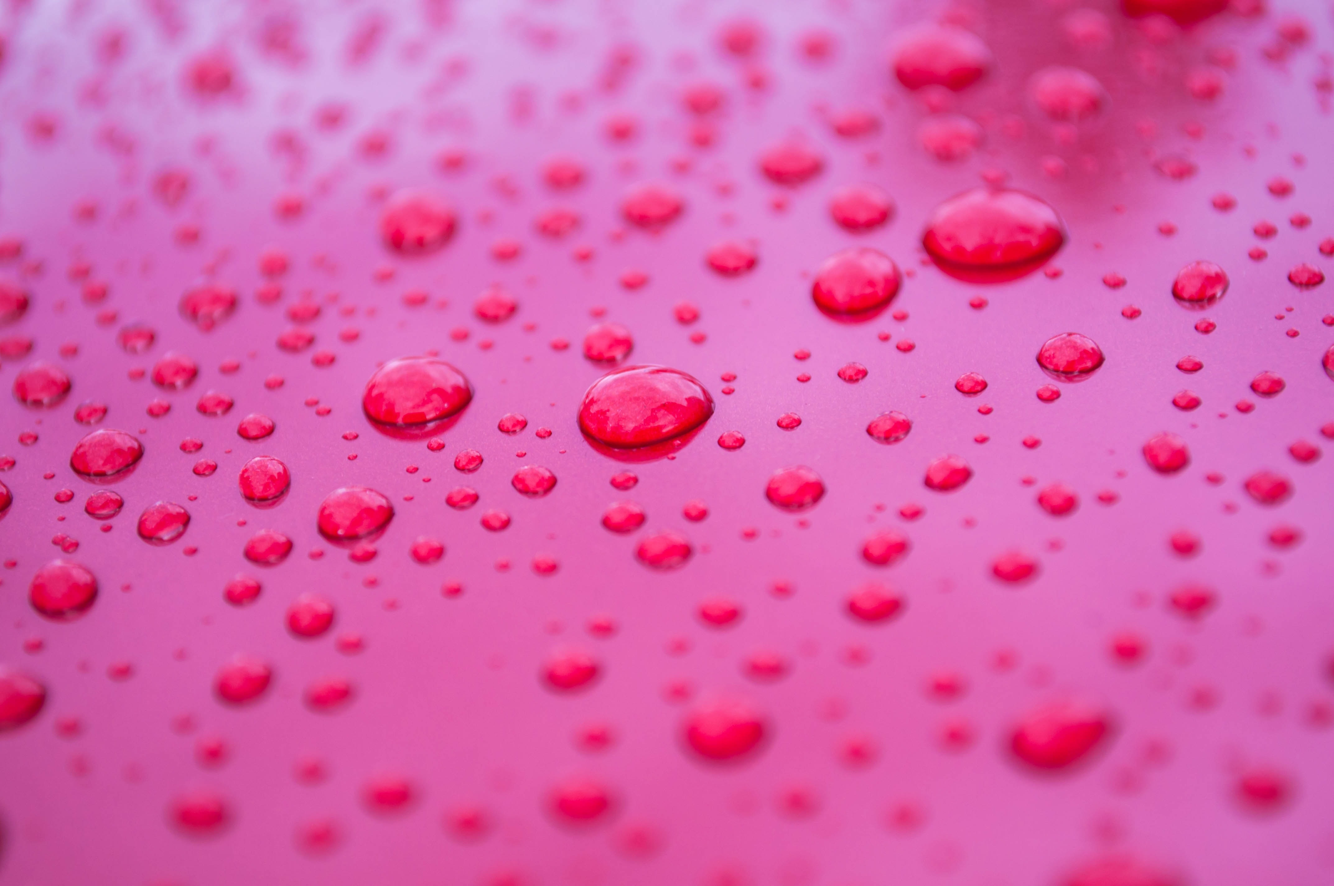 drops of water on red surface