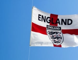 White and red England flag during day time thumbnail