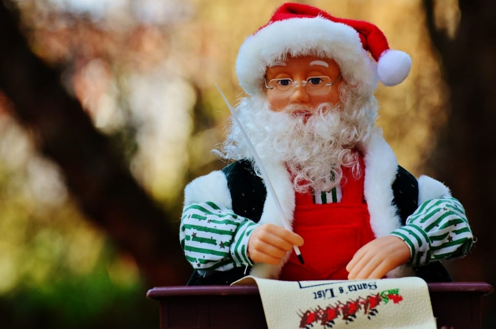 Santa Claus writing on paper doll selective focus photography preview