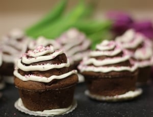 brown cupcake with white icing on top thumbnail