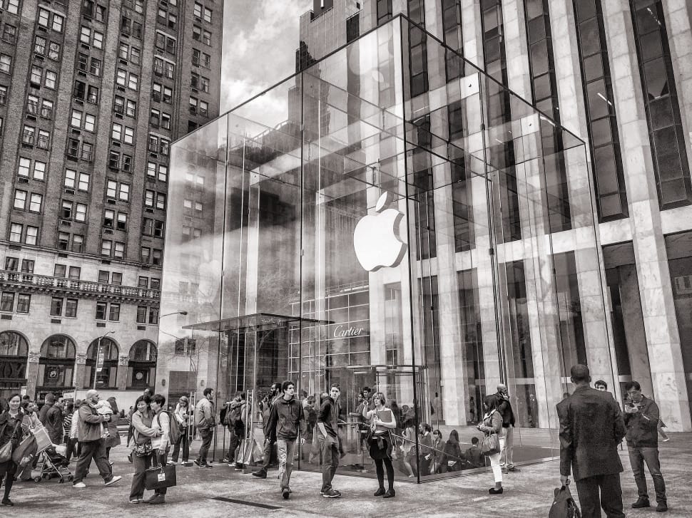gray scale photo of people in front of apple brand building preview