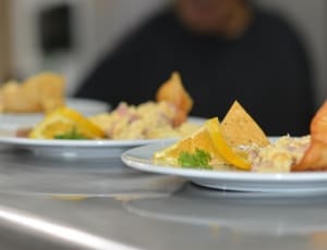 nachos with sauce on white ceramic round plate thumbnail