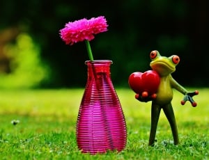 green frog holding heart ceramic figurine thumbnail