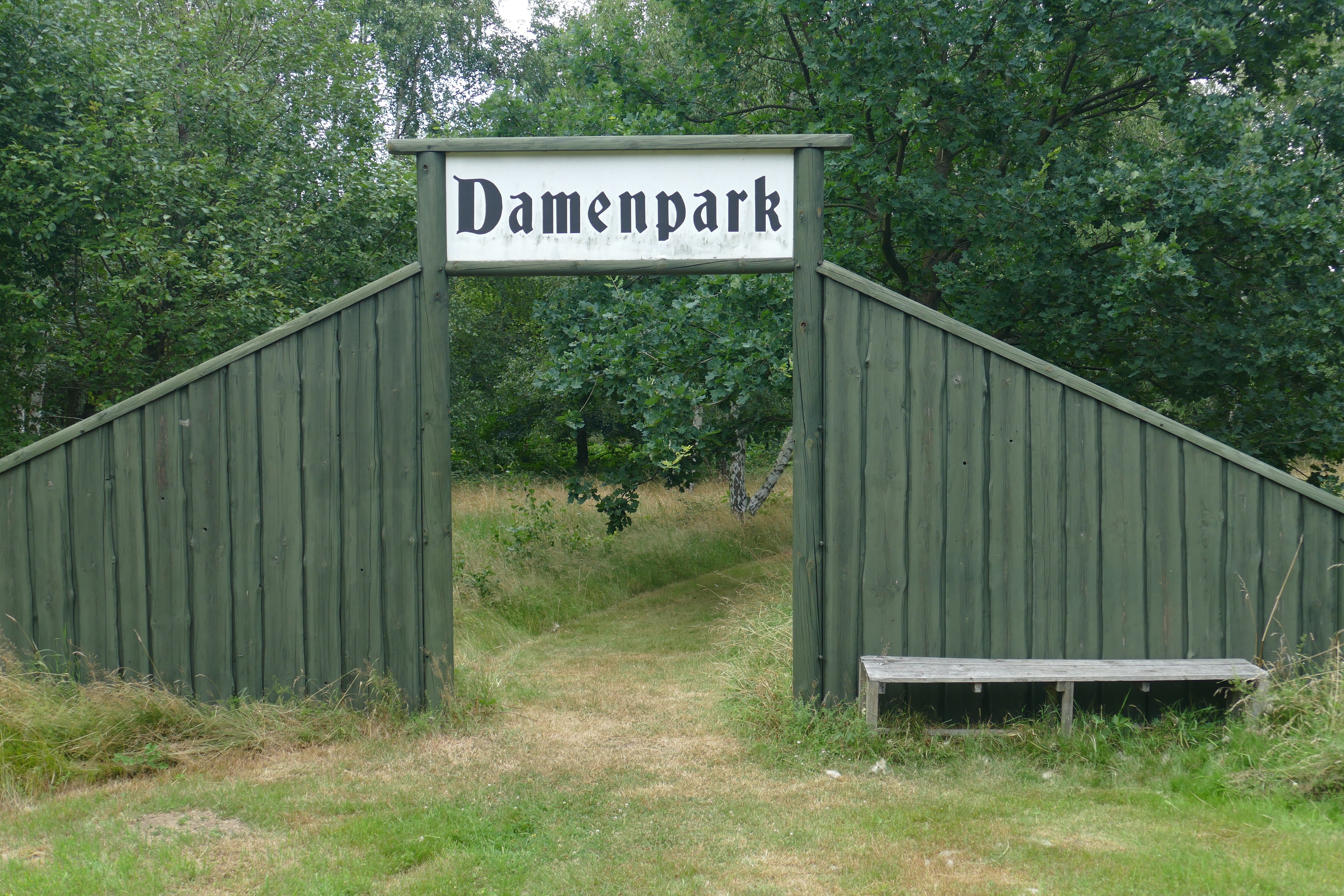 green wooden damenpark entrance arch