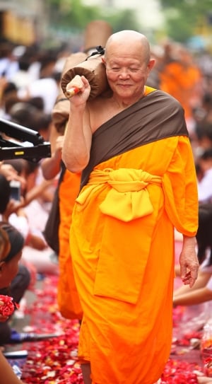 man in orange and brown sari thumbnail
