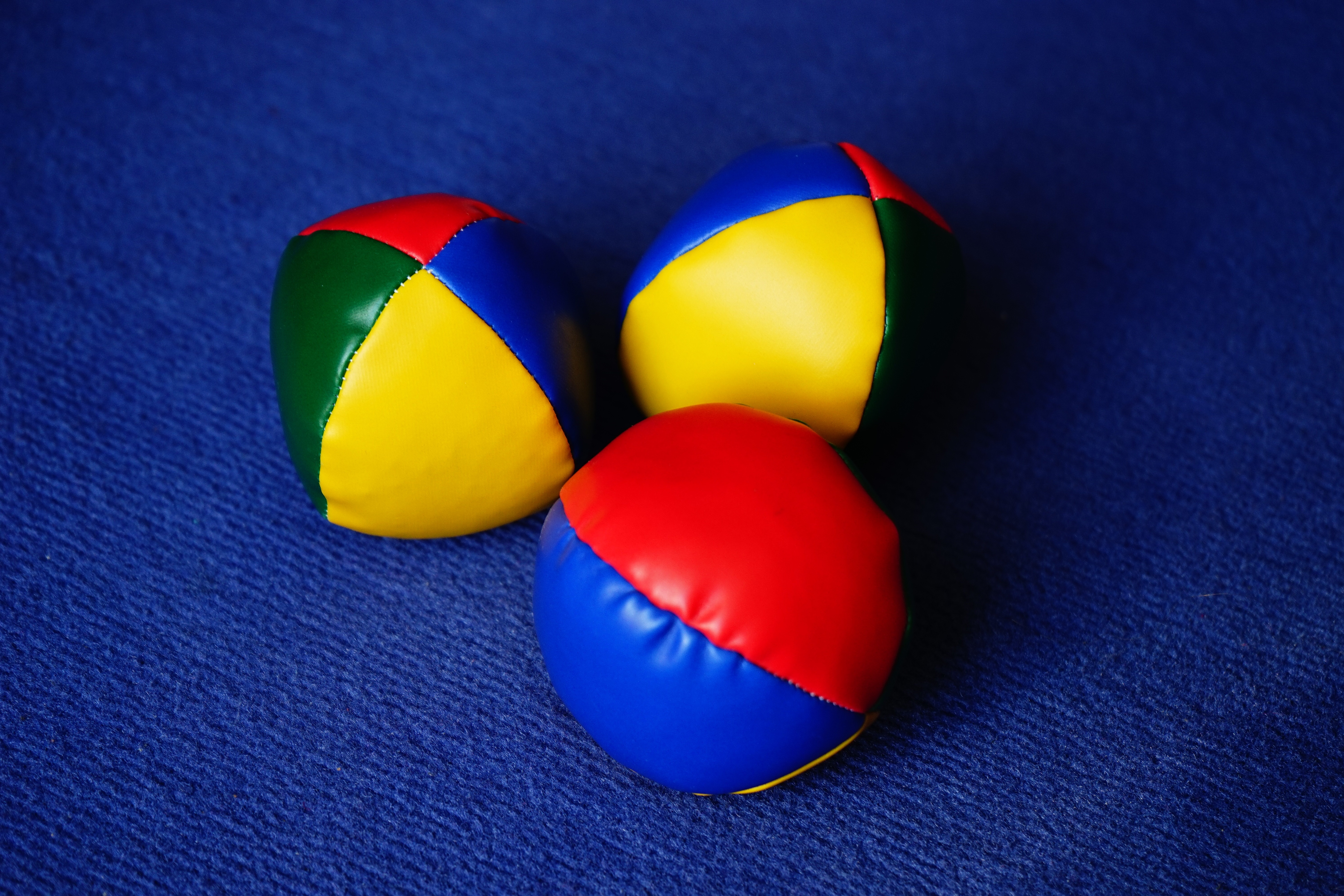 three blue yellow and green ball