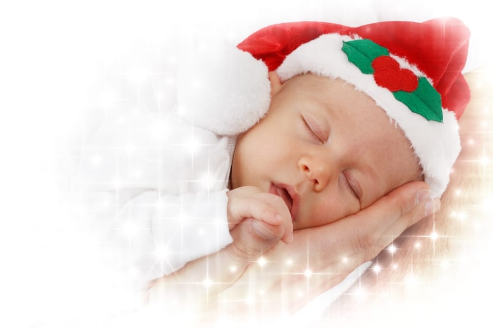 sleeping baby wearing red and white santa hat preview