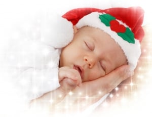 sleeping baby wearing red and white santa hat thumbnail