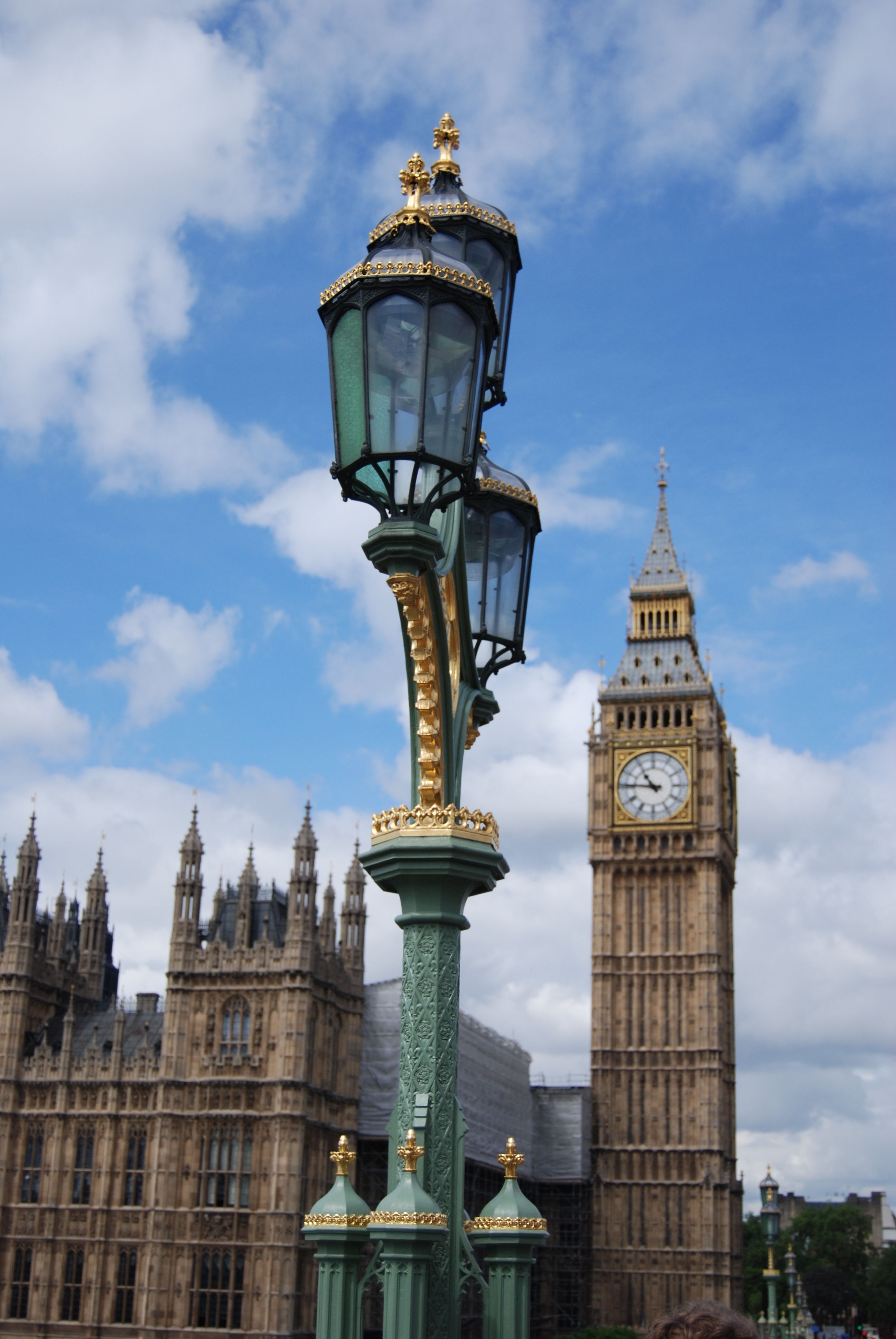 green and gold post lamp and big ben elizabeth tower