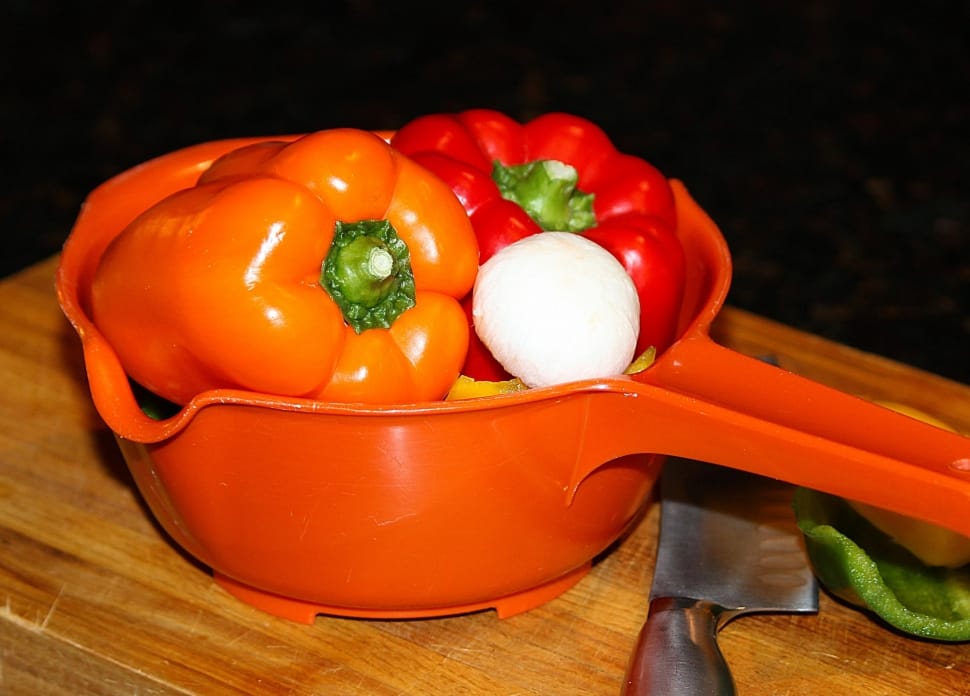 red and orange bell pepper on orange plastic dipper preview