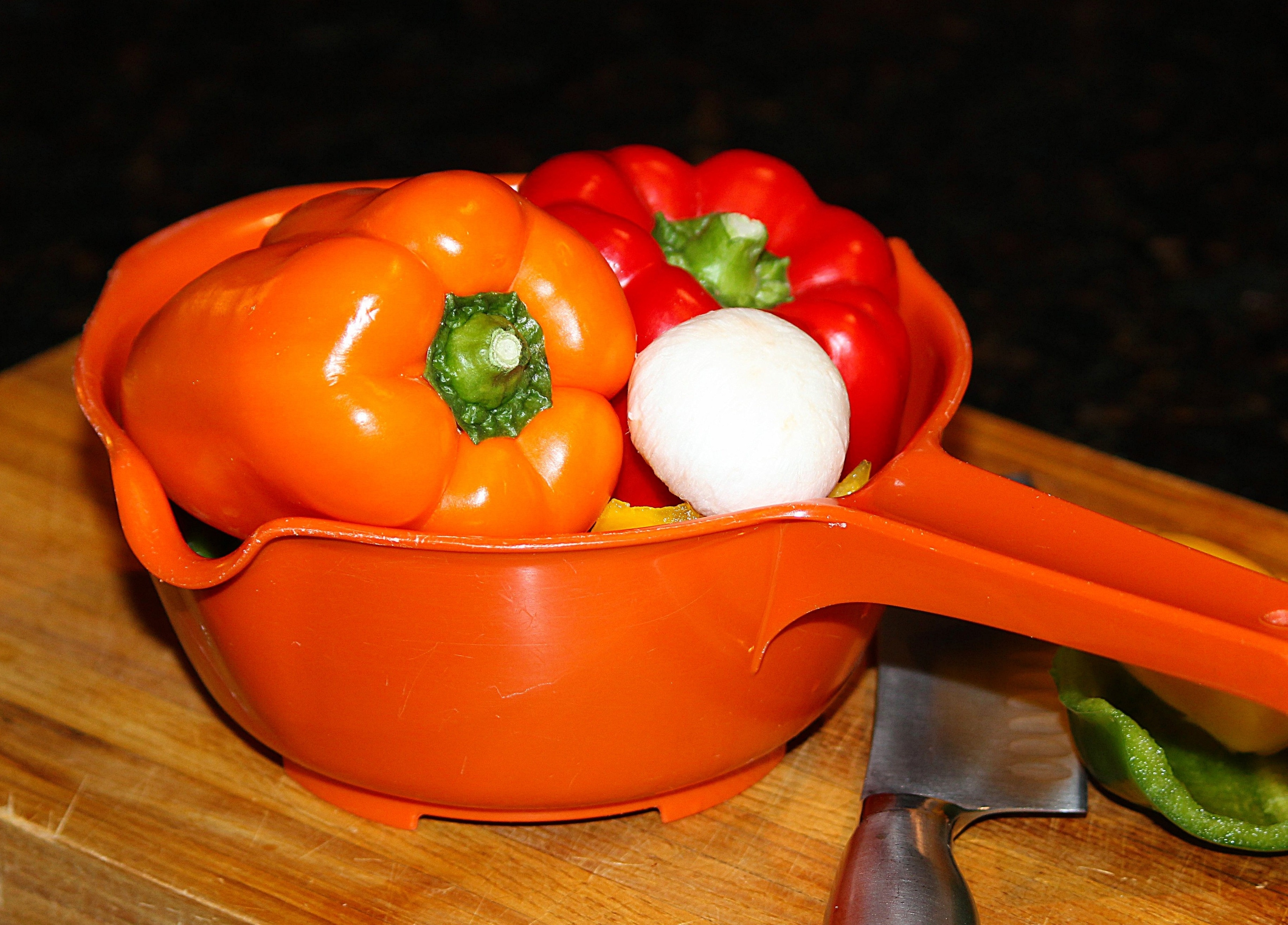 red and orange bell pepper on orange plastic dipper