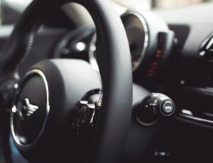black leather Mini Cooper steering wheel in tilt shift lens  photography thumbnail