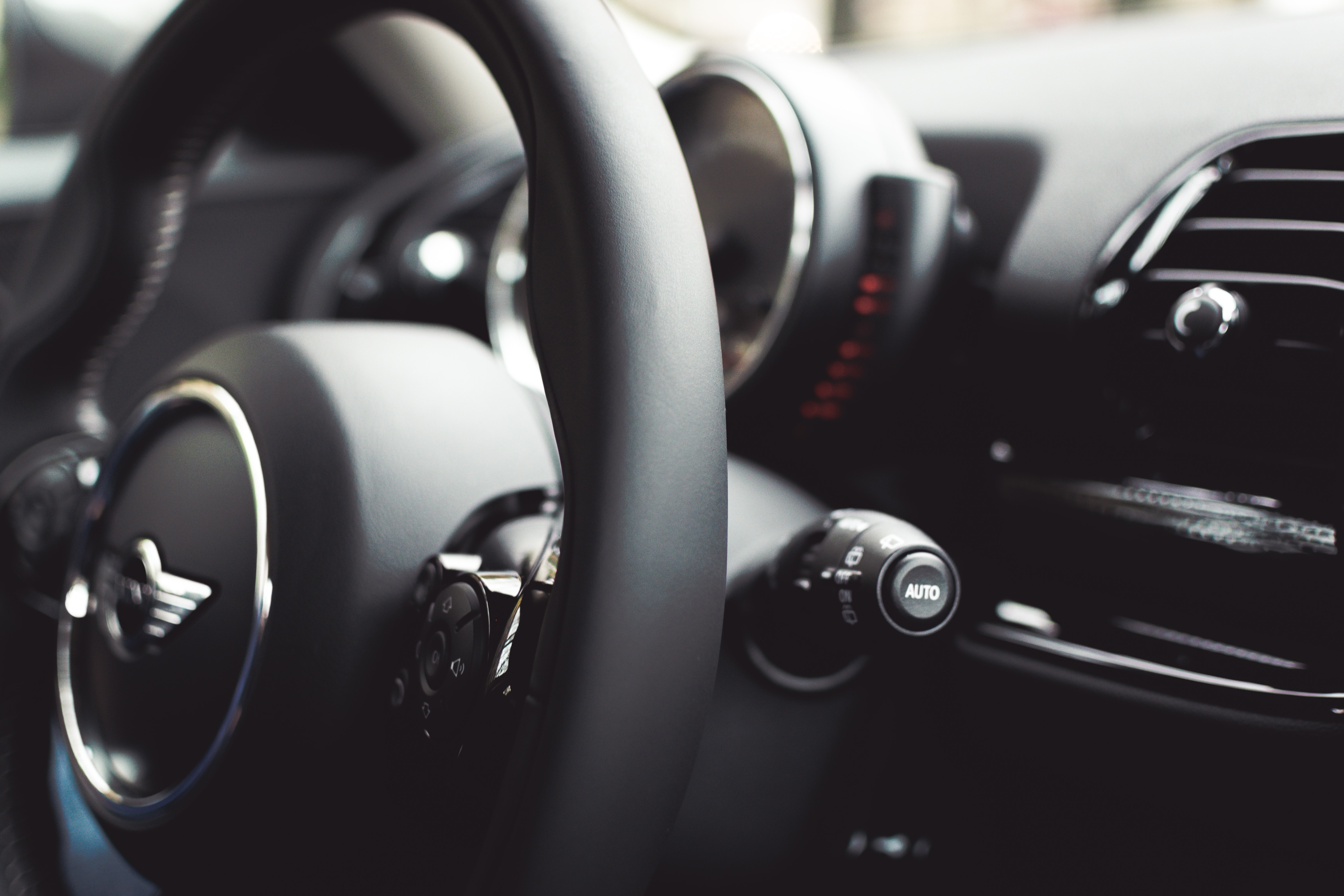 black leather Mini Cooper steering wheel in tilt shift lens  photography