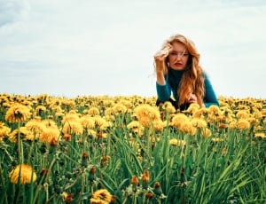 women's blue sweater and yellow sunflowers thumbnail