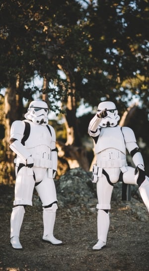 two storm troopers standing in front of trees thumbnail